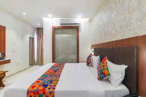 a bedroom with a large bed in a room at FabHotel Raj Palace in Lucknow