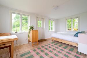 a bedroom with a bed and two windows at Mundekulla in Mundekulla