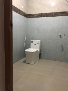 a bathroom with a toilet in a room at Hotel Nilneth Yala in Tissamaharama