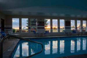 a large swimming pool with chairs and windows at Best Western Bronco Inn in Ritzville