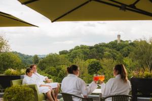 a group of people sitting around a table with drinks at Thermae 2000 in Valkenburg