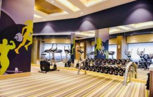 a gym with a bowling alley with exercise equipment at DLF Stay in Lucknow