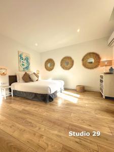 a bedroom with a bed and two mirrors on the wall at Les Appartements du Vieux Port in Marseille