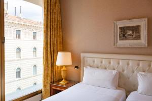 ein Hotelzimmer mit einem Bett und einem Fenster in der Unterkunft Hotel Internazionale in Bologna