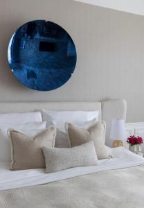 a bedroom with a bed with a blue mirror on the wall at Grand Hotel Oslo in Oslo