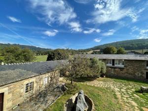 an external view of a stone house with a yard at Casa Grande de Láncara in Lugo