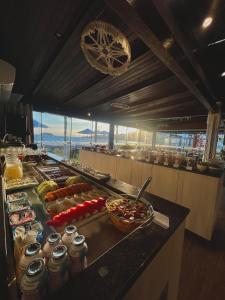 a buffet line with many different types of food at Hotel Sete Ilhas in Florianópolis