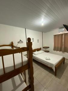 A bed or beds in a room at Hospedagem De Ferias