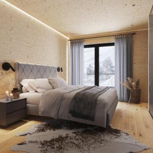 1 dormitorio con cama grande y ventana grande en Saalbach Suites by ALPS RESORTS en Saalbach Hinterglemm