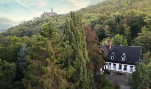 uma vista aérea de uma casa no meio de uma floresta em Hotel Mühlental em Wernigerode