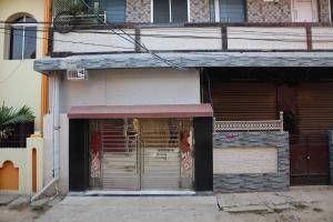 a store front with a door with a gate at Jagannatha Guest House in Puri