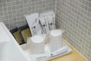 a bathroom counter with white towels and toothbrushes at みつくりHOTEL in Tuyama