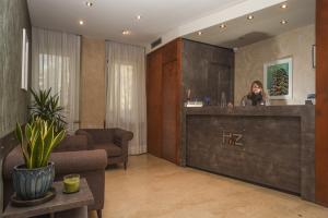 a woman at a reception desk in a hotel lobby at Hotel Zara Milano in Milan