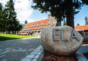 a large rock with the word eat on it in front of a building at "Park Hotel Ela" in Borovets