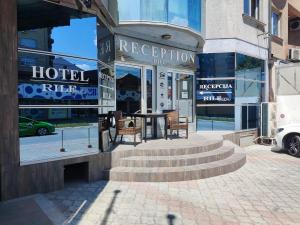 a hotel with a table in front of a building at Hotel Rile Men Blue in Niš