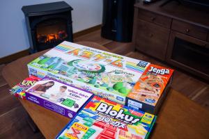 three boxes of magazines sitting on a table with a fireplace at 海風〜nami no oto〜 in Himi