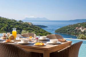 a table with food and drinks on it with a view at 2S Villas Resort in Sivota