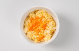 a bowl of mashed potatoes with cheese on a white surface at Garner Hotel Auburn - Seattle, an IHG Hotel in Auburn