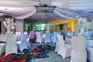 - une salle de banquet avec des tables et des chaises blanches dans l'établissement Embassy Suites by Hilton Los Angeles International Airport South, à El Segundo