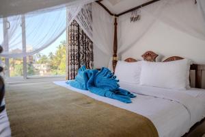 A bed or beds in a room at The Waves Unawatuna