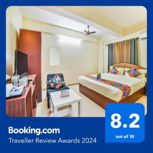 a hotel room with a bed and a tv at FabHotel K7 Trends With Pool, Baga Beach - Nr Baga Beach in Calangute