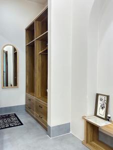 a dressing room with wooden cabinets and a mirror at Nhà Mer – Homestay đảo Phú Quý in Cu Lao Thu