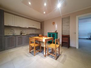 a kitchen with a wooden table and chairs at Asinara in Sassari