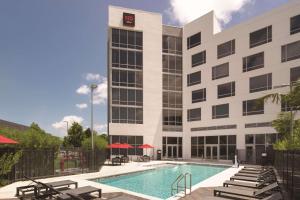 um hotel com piscina em frente a um edifício em Radisson RED Miami Airport em Miami