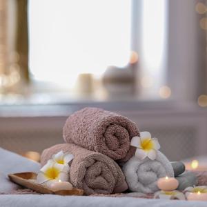 a pile of towels and flowers on a towel at Skeviks Gård in Gustavsberg