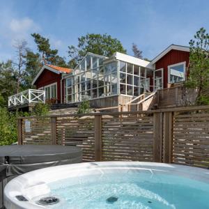 a jacuzzi tub in front of a house at Skeviks Gård in Gustavsberg