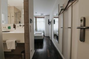 a bathroom with a sink and a toilet at Design Hotel & Restaurant Löwen in Ulm