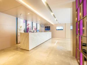 a lobby with a reception desk in a building at Lavande Hotel Beijing International Exhibition Heping Xiqiao Metro Station in Beijing