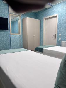 2 Betten in einem Zimmer mit blauen Wänden in der Unterkunft Address Boutique Hotel Baku in Baku