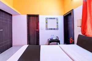 A bed or beds in a room at Hotel O Home Modern Stay Near Iter