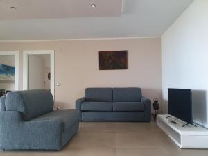 a living room with a couch and a tv at Asinara in Sassari