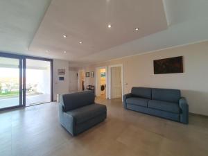 a living room with a couch and a chair at Asinara in Sassari