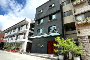 un edificio con una puerta roja en una calle en Dafong Hotel en Zhongzheng