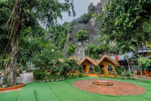 un jardín con una casa frente a una montaña en Tam Coc Bungalow en Ninh Binh