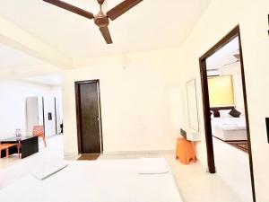 a living room with a mirror and a bed at HOTEL G RESORT ! PURI Swimming-pool-and-Garden, near-sea-beach-and-temple fully-air-conditioned-hotel with-lift-and parking-facility, Breakfast included, best hotel in puri - 2 in Puri