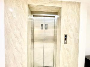 a elevator in a building with marble walls at HOTEL G RESORT ! PURI Swimming-pool-and-Garden, near-sea-beach-and-temple fully-air-conditioned-hotel with-lift-and parking-facility, Breakfast included, best hotel in puri - 2 in Puri