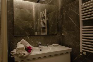 a bathroom with a sink with a towel on it at Palazzo Fiammingo Rooms in Belpasso