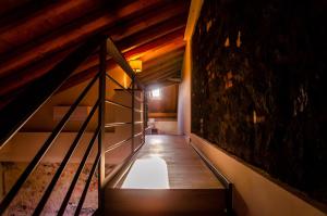 an attic hallway with a staircase in a house at Palazzo Fiammingo Rooms in Belpasso