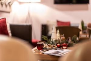 a table with a plate of food and drinks on it at Boutique Hotel Atrium München in Munich