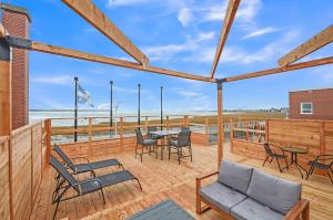 a patio with a table and chairs and a view of the ocean at Lofts Orizon in Rimouski