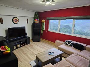 a living room with a couch and a flat screen tv at La Torre, vistas a la bahía in Laredo