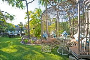 a bird cage with blue and white vases in it at Mantra Club Croc in Airlie Beach