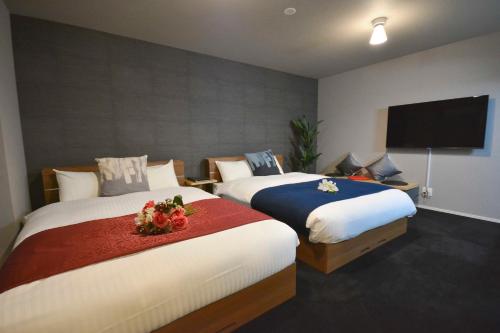 Tempat tidur dalam kamar di The Grand Residence Hotel Tenjin