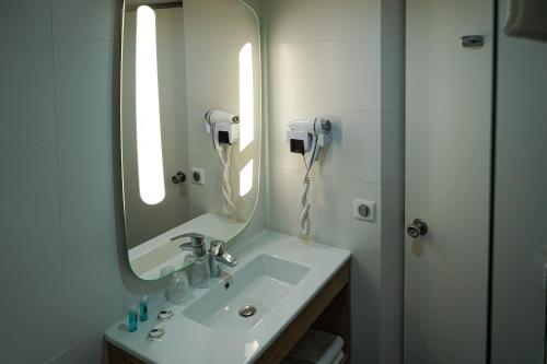 La salle de bains est pourvue d'un lavabo avec miroir et d'un téléphone. dans l'établissement ibis Styles Marseille Centre Prado Place Castellane, à Marseille