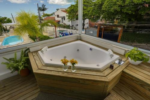 a bath tub sitting on top of a balcony at Solar Beach Hotel in Florianópolis