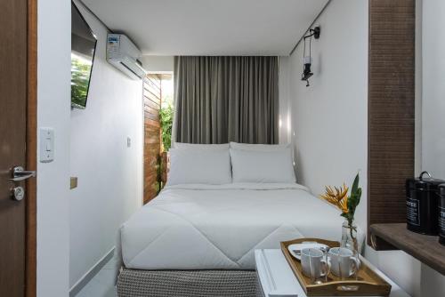 Tempat tidur dalam kamar di Casa Villa Noronha Suites